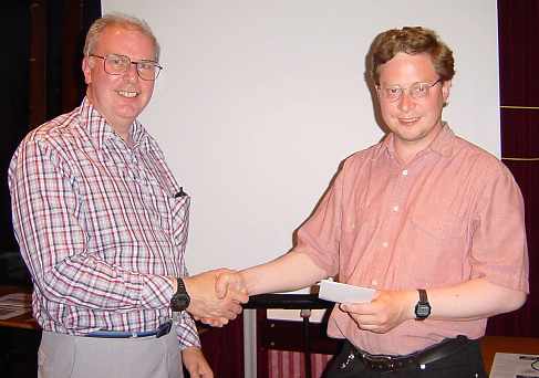 Dick presenting Anthony with the winning Prize