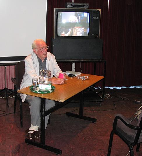 Les seated infront of the video monitor