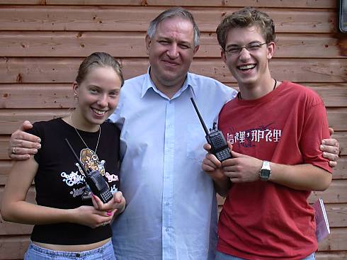 Phil Osborne G4RPF presenting handhelds to Michelle Stiffel and Hugh Montgomerie